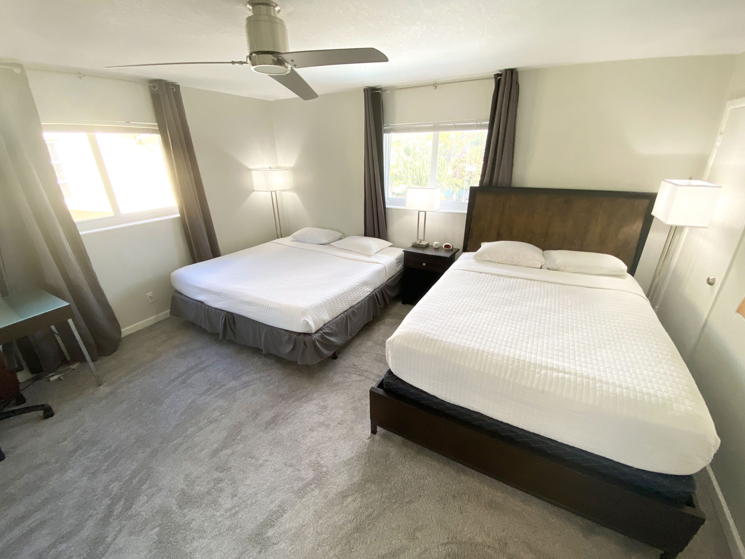 Master bedroom with two beds and ceiling fan at Tarpon Harbor 1