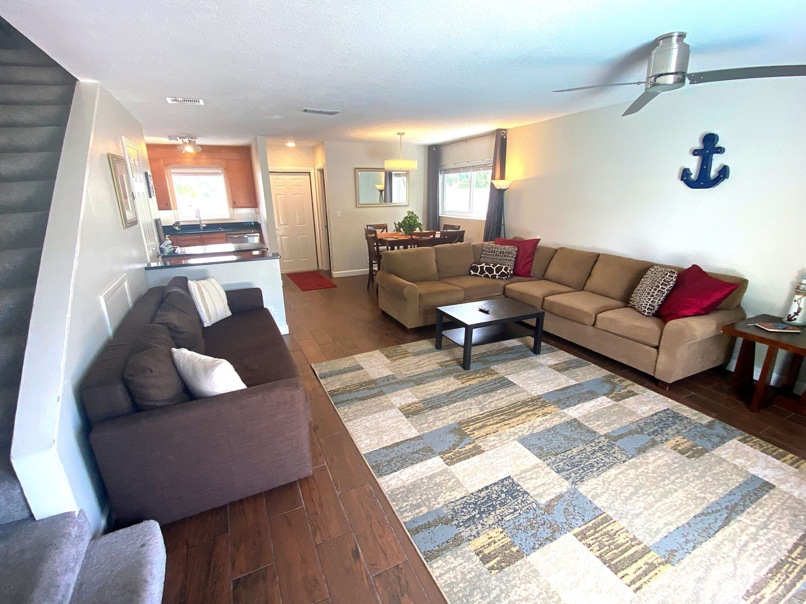 Living room with sectional sofa, sleeper sofa and kitchen at Tarpon Harbor 1