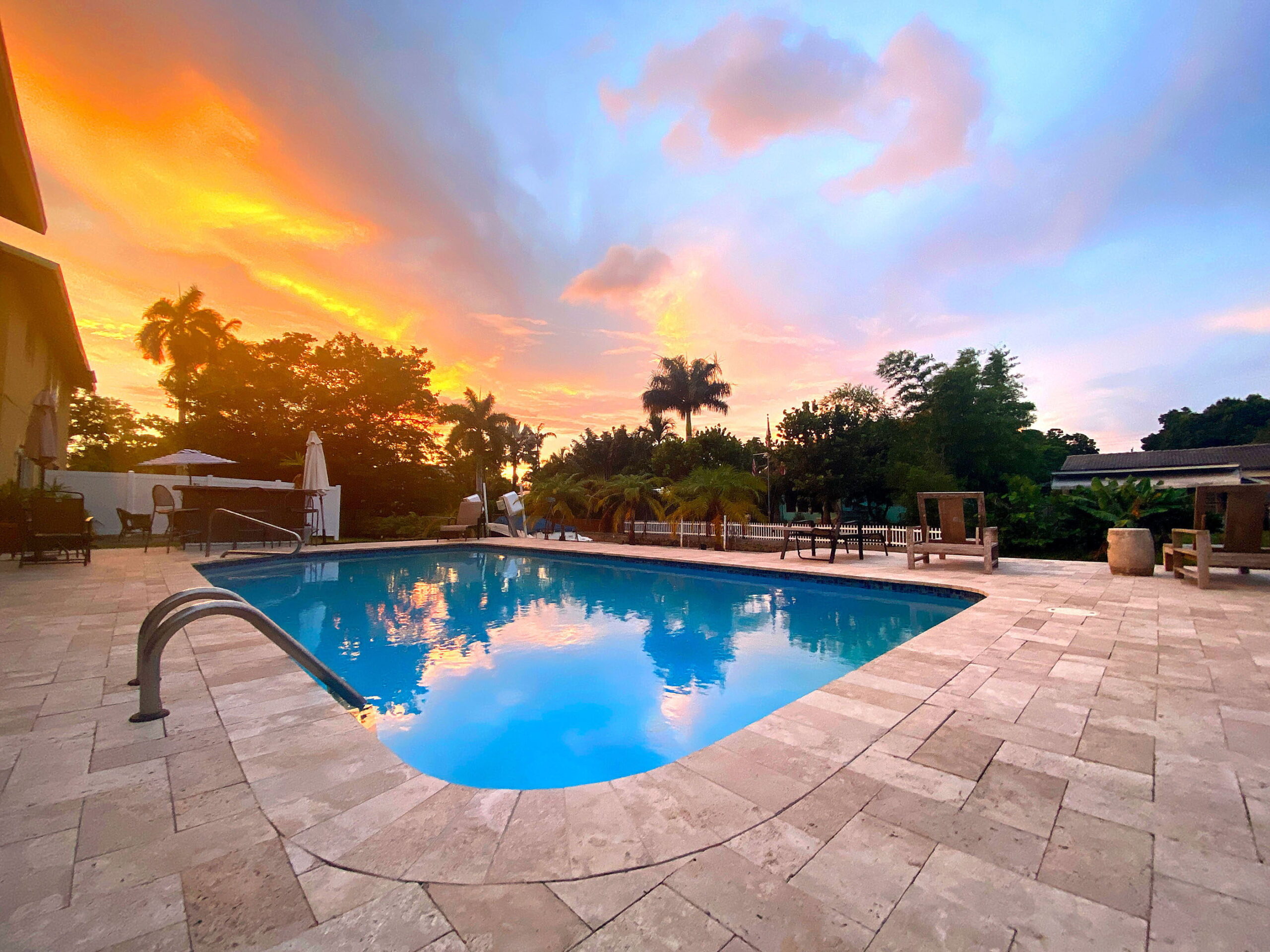 Fort Lauderdale vacation rental pool surrounded by tropical landscaping at sunset at Tarpon Harbor 1